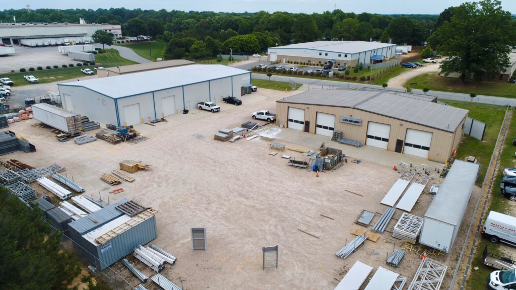 Aerial view of industrial buildings with a large outdoor storage yard north of Charlotte