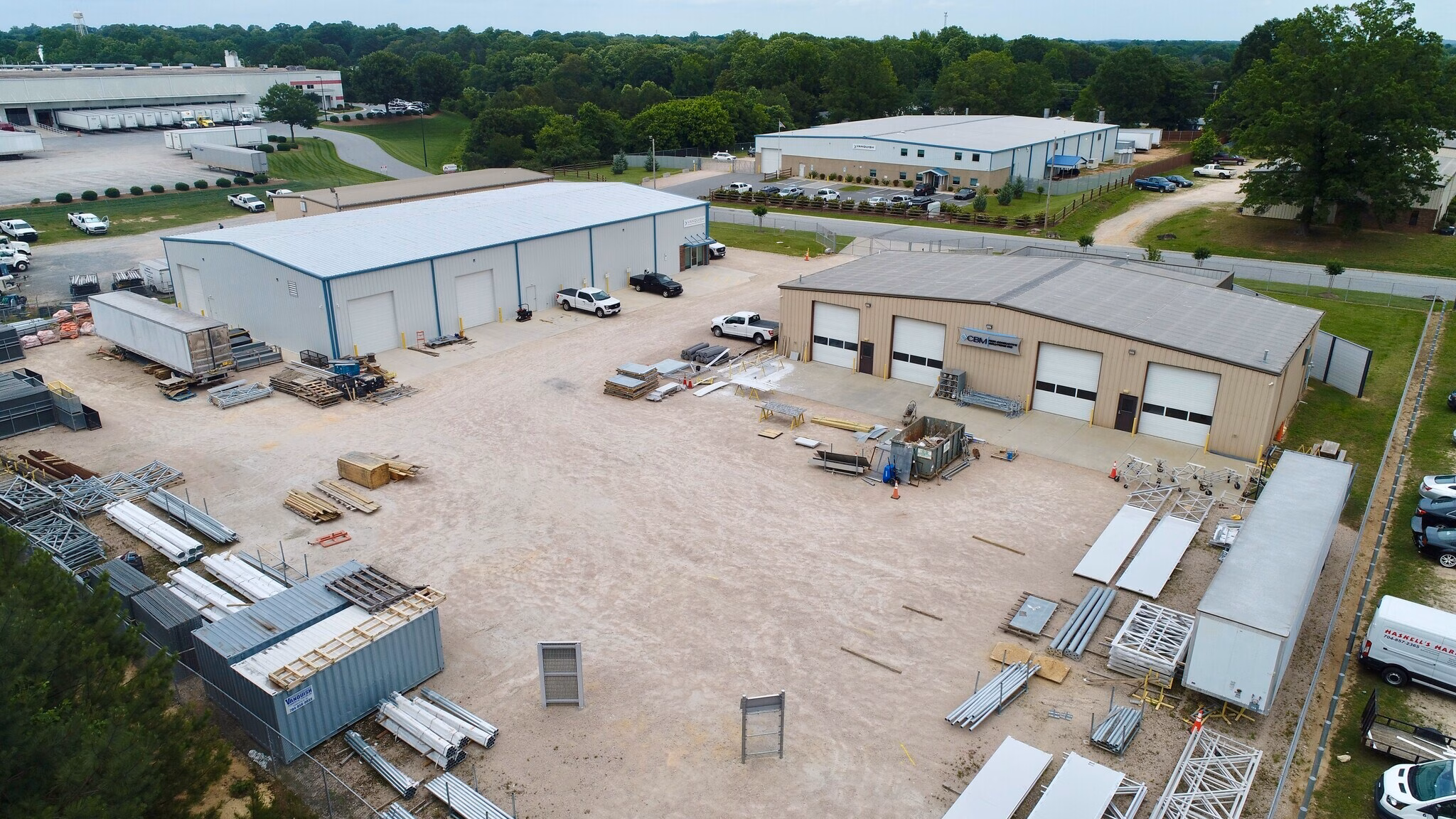 Aerial view of industrial buildings with a large outdoor storage yard north of Charlotte